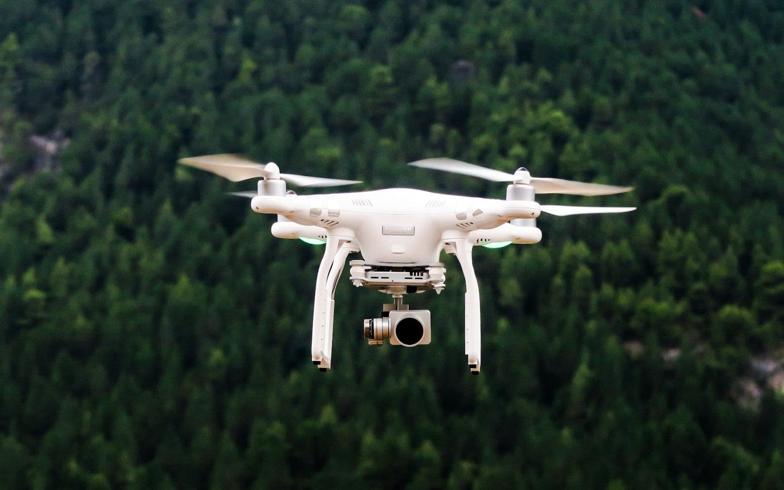 Aerial survey drone flying over a landscape, illustrating UAV photogrammetry from flight planning to orthomosaic generation