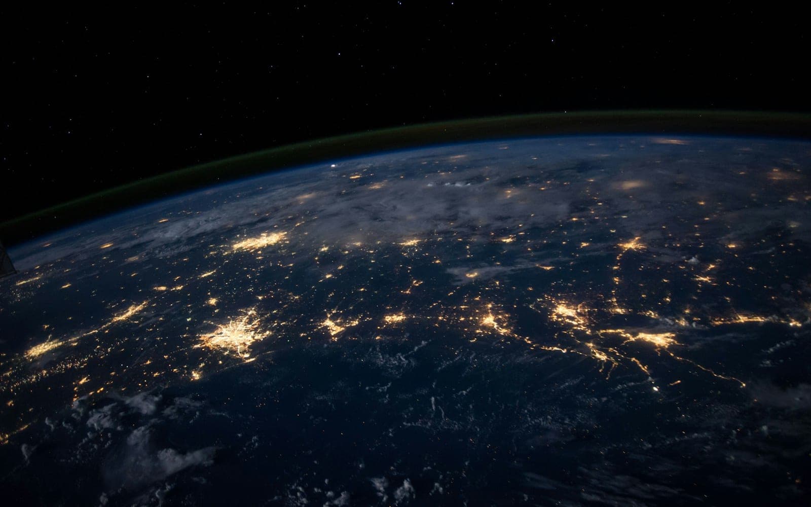 View of Earth from space with glowing connected lights, evoking Google Earth Engine planetary-scale cloud processing of satellite data