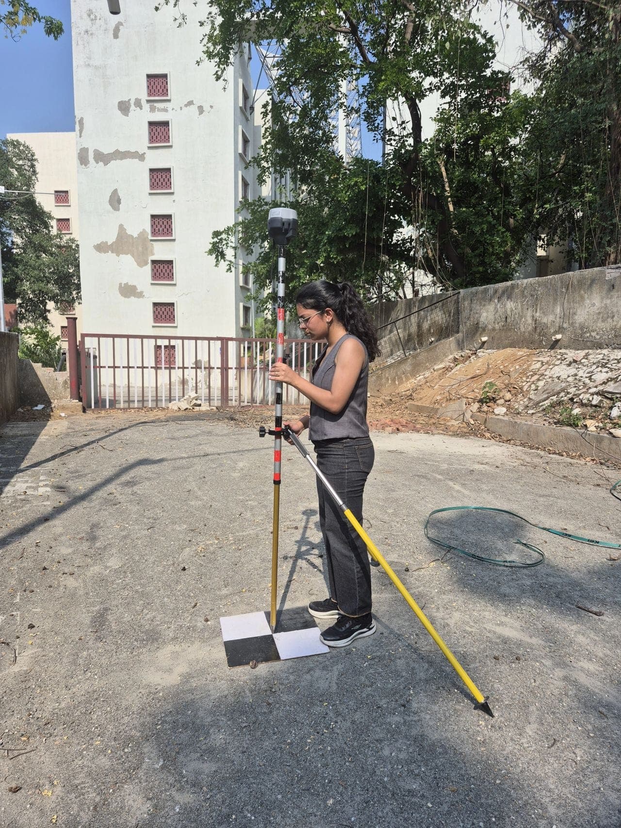 Jannat Khosla collecting GNSS ground control with survey equipment in the field